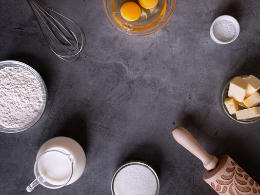 a table topped with bowls of food and a whisk